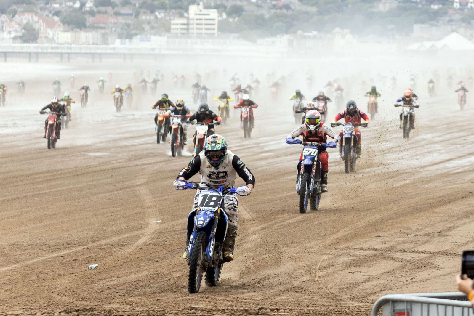 Hundreds of motorbikes race through the sand and spray at the start of the Weston-super-Mare Beach Race